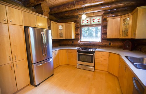 The kitchen in this Charleswood home mixes modern stainless step appliances with the rustic wood feel of the home in Winnipeg on Tuesday, July 21, 2015.   Mikaela MacKenzie / Winnipeg Free Press