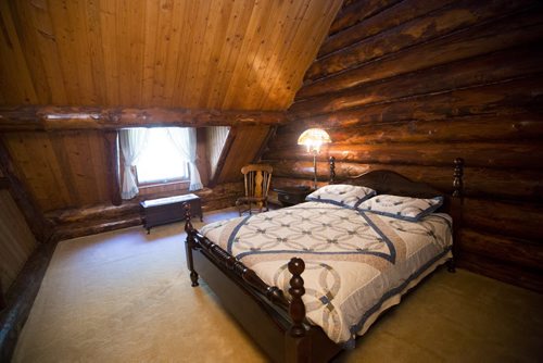 The master bedroom has a cozy feel with a sloped ceiling in this Charleswood home in Winnipeg on Tuesday, July 21, 2015.   Mikaela MacKenzie / Winnipeg Free Press