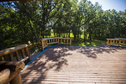 The expansive deck provides a comfortable place to take in the nature surrounding this Charleswood home in Winnipeg on Tuesday, July 21, 2015.   Mikaela MacKenzie / Winnipeg Free Press