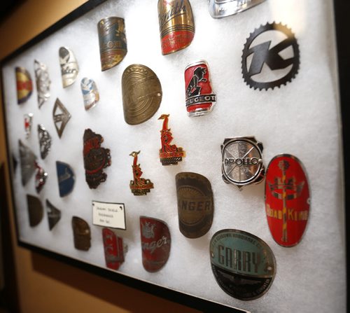 Sunday. This City . The story is on Woodcock Cycle Works and owner Tim Woodcock. This is a framed collection of bicycle head badges from 1909-2011 in his office.  Dave Sanderson story Wayne Glowacki / Winnipeg Free Press July 21 2015