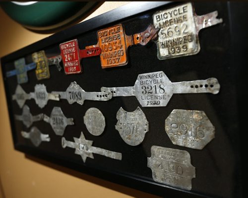 Sunday. This City. The story is on Woodcock Cycle Works and owner Tim Woodcock. This is a framed collection City of Winnipeg license plates in his office.  Dave Sanderson story Wayne Glowacki / Winnipeg Free Press July 21 2015