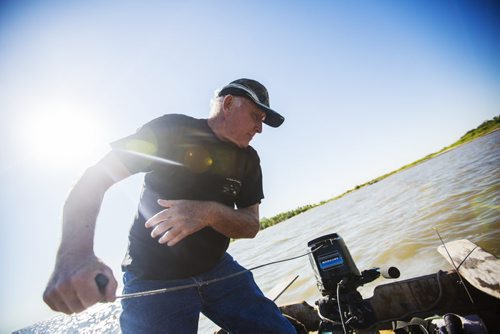 Charlie MacPherson starts the motor before heading off towards the Netley-Libau March just off Lake Winnipeg on Wednesday, July 22, 2015.  Because of continuous high water levels, the marsh ecosystem is suffering in many ways. Mikaela MacKenzie / Winnipeg Free Press
