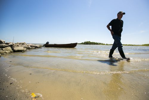 Charlie MacPherson walks back to shore after visiting the Netley-Libau March just off Lake Winnipeg on Wednesday, July 22, 2015.  Because of continuous high water levels, the marsh ecosystem is suffering in many ways. Mikaela MacKenzie / Winnipeg Free Press