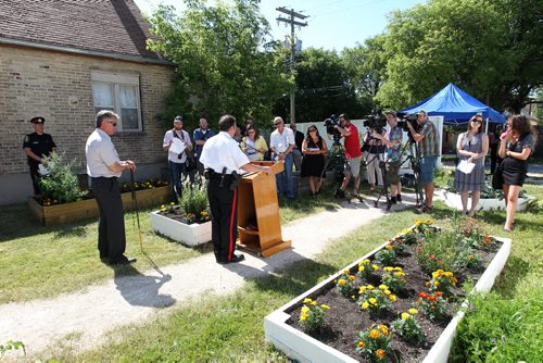 The Winnipeg Police hold media briefing regarding the release of Winnipeg Police Service's 2014 Annual Report at Selkirk Community Garden Wednesday morning.  Superintendent Danny Smyth (in white uniform),  City councillor Ross Eadie, Mynarski ward was also in attendance backing the report.      July 22,, 2015 Ruth Bonneville / Winnipeg Free Press