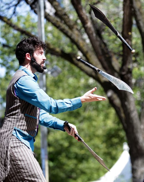 Catch That Act...Michael Armstrong, or on stage aka "Mr Wizowski" juggles knives for the crowd's entertainment Wednesday afternoon at the Fringe Festival's free stage in Old MArket Square. July 22, 2015 - (Phil Hossack / Winnipeg Free Press)