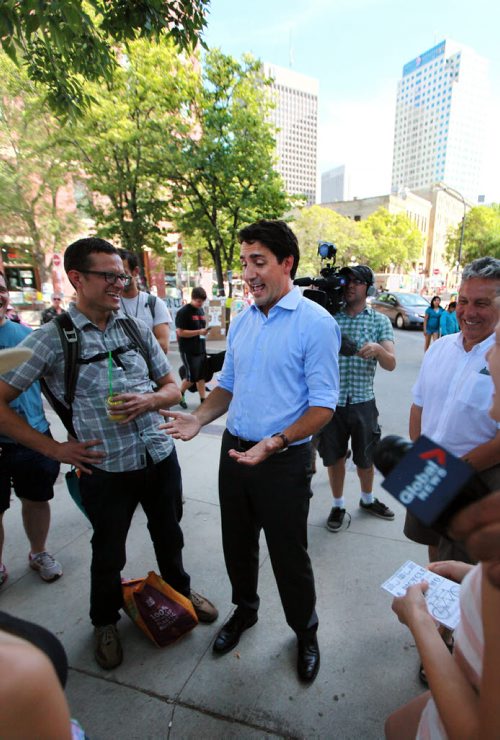 Liberal Leader Justin Trudeau banters with participants at the Winnipeg Fringe Festival Wednesday afternoon as he dropped by Old Market Square for a visit. See Geoff Kirbyson's story. July 22, 2015 - (Phil Hossack / Winnipeg Free Press)