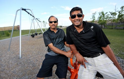 Dost Mughal, left, and Anis Khan, in what will soon be named "Malala Park," at the southern end of Paddington Road, named after Pakistan's Malala Yousafzai, Wednesday, July 22, 2015. (TREVOR HAGAN/WINNIPEG FREE PRESS)
