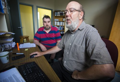 Glenn Morison, executive director at Open Circle, works with participant Rob Beer in his office in Winnipeg on Thursday, July 23, 2015.  Mikaela MacKenzie / Winnipeg Free Press