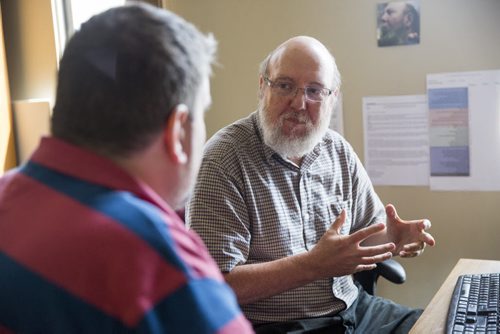 Glenn Morison, executive director at Open Circle, talks to participant Rob Beer in his office in Winnipeg on Thursday, July 23, 2015.  Mikaela MacKenzie / Winnipeg Free Press