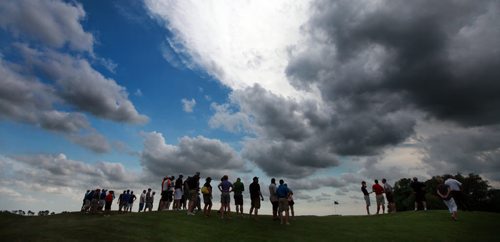 Spectators gather on the 18th hole of the Manitoba Mens Amature Golf tournament at Bridges Golf Course in Starbuck Thursday under a gathering storm. Devon Schade came in to win the tournament while Ryan Sholdice finished 2nd in the provincial title. See Story. July 23, 2015 - (Phil Hossack / Winnipeg Free Press)