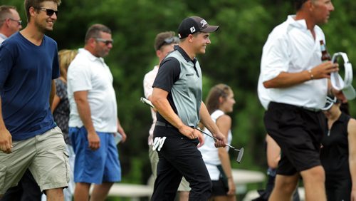 Surrounded by fans a happy Devon Schade walks to the scoring table Thursday at the Manitoba Amature Thursday afternoon at Bridges Golf Course in Starbuck Mb. Schade came in to win the tournament while Ryan Sholdice finished 2nd in the provincial title. See Story. July 23, 2015 - (Phil Hossack / Winnipeg Free Press)