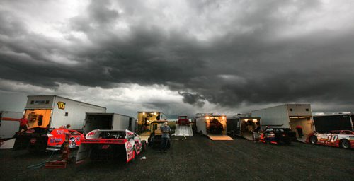 Drivers and crew check their smartphone weather at Red River Raceway Thursday evening. Racers prepped under the looming weather and got one race in before the sky opened up and cancelled the races till Monday night. July 23, 2015 - (Phil Hossack / Winnipeg Free Press)