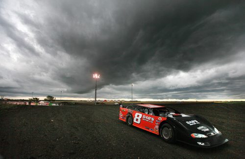 A car leaves the track after hot lap warm ups at Red River Raceway Thursday evening. Racers prepped under the looming weather and got one race in before the sky opened up and cancelled the races till Monday night. July 23, 2015 - (Phil Hossack / Winnipeg Free Press)