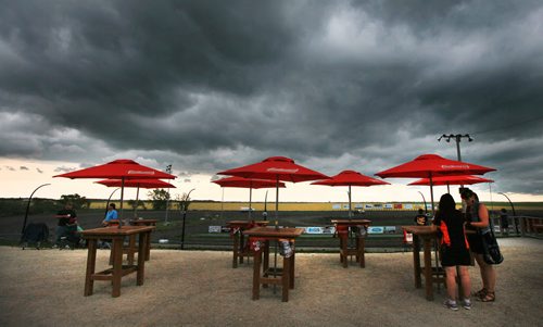 Bright sun shades stand in contrast to a dark sky at Red River Raceway Thursday evening. Racers prepped under the looming weather and got one race in before the sky opened up and cancelled the races till Monday night. July 23, 2015 - (Phil Hossack / Winnipeg Free Press)