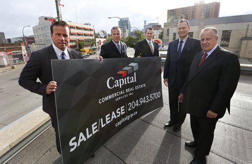 From left, Carey Chartier, Principal, Derrick Chartier, Principal, Trevor Clay, Principal, Rennie Zegalski, Principal and Marcel Chartier, Broker with a Capital Commercial Real Estate Services sign. The local office of real estate firm CBRE on Portage Ave is rebranding to Capital Commercial Real Estate Services.¤Geoff Kirbyson story. Wayne Glowacki / Winnipeg Free Press July 24 2015