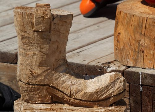 Russ Kubara displays his techniques on how to carve wood with a chainsaw at Tyndall Firewood Supply Ltd near Tyndall, Manitoba  - He teaches workshops in spring and fall- Boot that he carved that he is still working on-See David Sanderson story- July 23, 2015   (JOE BRYKSA / WINNIPEG FREE PRESS)
