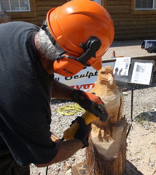 Russ Kubara displays his techniques on how to carve wood with a chainsaw and other small tools( Small grider in this shot) at Tyndall Firewood Supply Ltd near Tyndall, Manitoba  - He teaches workshops in spring and fall-See David Sanderson story- July 23, 2015   (JOE BRYKSA / WINNIPEG FREE PRESS)