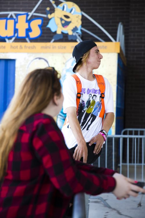 One direction fans Austin Klotz and Jessica Krotowich wait and look into the stadium four hours before the show at the Investors Group Field in Winnipeg on Friday, July 24, 2015.  Mikaela MacKenzie / Winnipeg Free Press