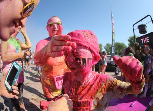 Declan Petrash, 8, has coloured gel wiped off his face following the Colour Me Rad 5km run at the Red River Ex grounds, Saturday, July 25, 2015. (TREVOR HAGAN/WINNIPEG FREE PRESS)