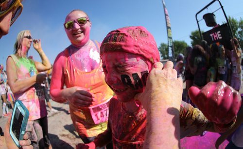 Declan Petrash, 8, has coloured gel wiped off his face following the Colour Me Rad 5km run at the Red River Ex grounds, Saturday, July 25, 2015. (TREVOR HAGAN/WINNIPEG FREE PRESS)