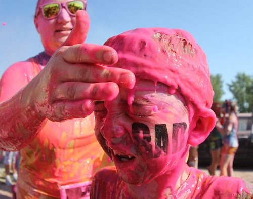 Declan Petrash, 8, has coloured gel wiped off his face following the Colour Me Rad 5km run at the Red River Ex grounds, Saturday, July 25, 2015. (TREVOR HAGAN/WINNIPEG FREE PRESS)