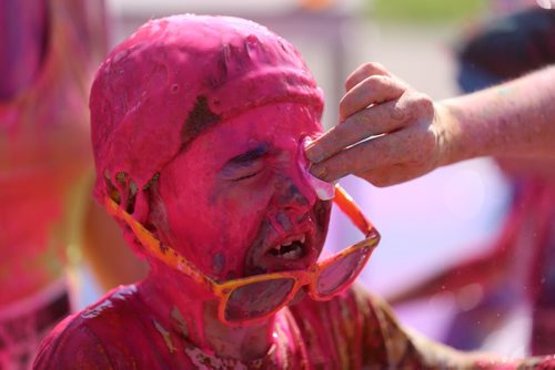 Declan Petrash, 8, has coloured gel wiped off his face following the Colour Me Rad 5km run at the Red River Ex grounds, Saturday, July 25, 2015. (TREVOR HAGAN/WINNIPEG FREE PRESS)