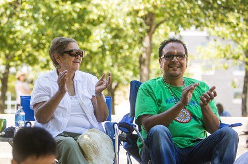 Elder Sylvia James and regional chief Kevin Hart clap to the music at the No Stone Unturned event in honouring Manitobas missing and murdered at the Forks in Winnipeg on Saturday, July 25, 2015.  Mikaela MacKenzie / Winnipeg Free Press