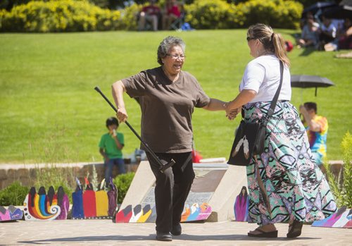 Margaret Osborne picks up her cane and dances with her granddaughter, Bernadette Smith, at the No Stone Unturned event in honouring Manitobas missing and murdered at the Forks in Winnipeg on Saturday, July 25, 2015.  Mikaela MacKenzie / Winnipeg Free Press