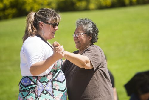 Bernadette Smith (left) dances with her grandmother, Margaret Osborne, at the No Stone Unturned event in honouring Manitobas missing and murdered at the Forks in Winnipeg on Saturday, July 25, 2015.  Mikaela MacKenzie / Winnipeg Free Press