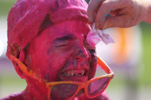 Declan Petrash, 8, gets coloured gel wiped off his eyes after the Colour Me Rad run at the Red River Ex Grounds, Saturday, July 25, 2015. (TREVOR HAGAN / WINNIPEG FREE PRESS)