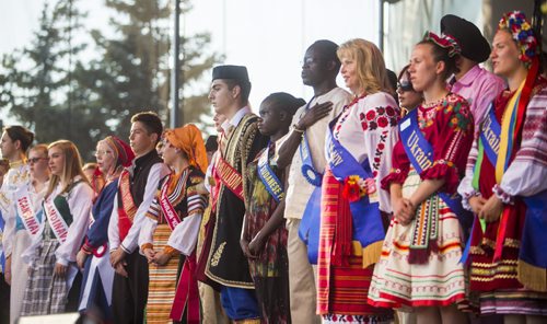 Pavilion representatives sing Oh Canada together on stage as Folklorama kicks off at the Forks in Winnipeg on Saturday, July 25, 2015.  Mikaela MacKenzie / Winnipeg Free Press