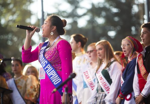 Aplril Llave sings Oh Canada with all of the pavilion representatives as Folklorama kicks off at the Forks in Winnipeg on Saturday, July 25, 2015.  Mikaela MacKenzie / Winnipeg Free Press