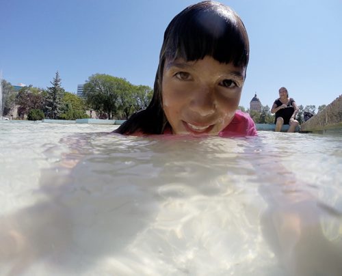 Hannah Bruce, 8, swims in the fountain at Memorial Park as her aunt, Phyllis looks on, Sunday, July 26, 2015. (TREVOR HAGAN/WINNIPEG FREE PRESS)