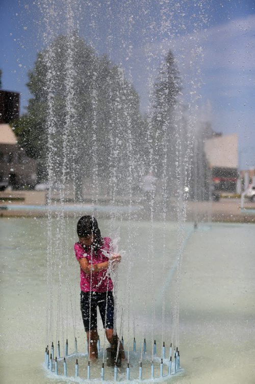 Hannah Bruce, 8, swims in the fountain at Memorial Park, Sunday, July 26, 2015. (TREVOR HAGAN/WINNIPEG FREE PRESS)