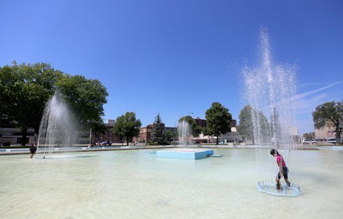 Hannah Bruce, 8, swims in the fountain at Memorial Park, Sunday, July 26, 2015. (TREVOR HAGAN/WINNIPEG FREE PRESS)