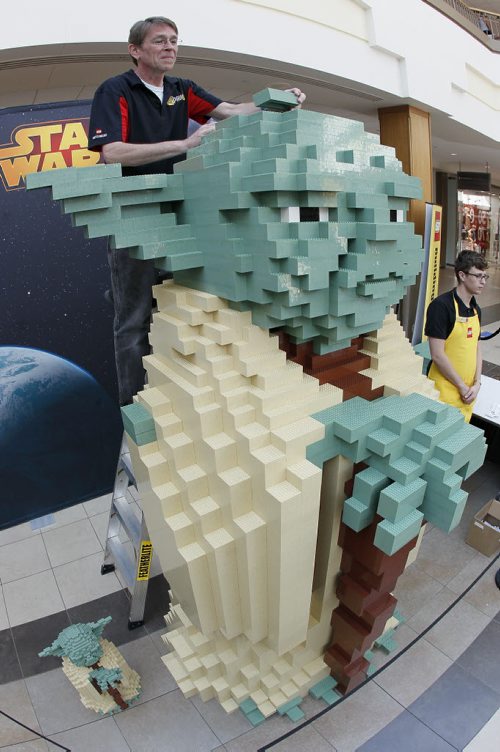 July 26, 2015 - 150726  -  Paul Chrzan, Lego master model builder, puts the finishing touches on an 8 foot tall Yoda during a Lego promotional event at Polo Park Shopping Centre Sunday, July 26, 2015. John Woods / Winnipeg Free Press