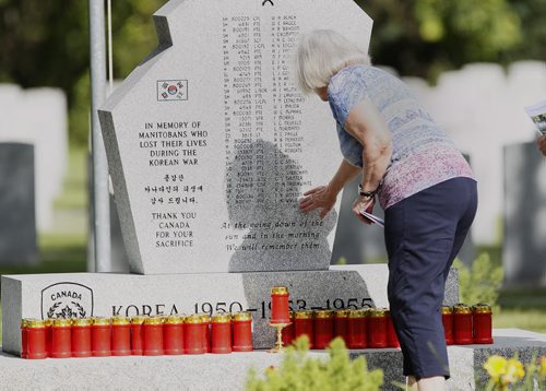 July 26, 2015 - 150726  - A woman remembers the people who gave their lives in the Korean war during a ceremony in Winnipeg this afternoon,  Monday, July 27, 2015. Members of Unit 17 (Manitoba) of the Korea Veterans Association held a candlelight service at Brookside Cemetery  to honour the 516 who gave their lives during  the Korean War that ended with a ceasefire to hostilities on July 27, 1953.