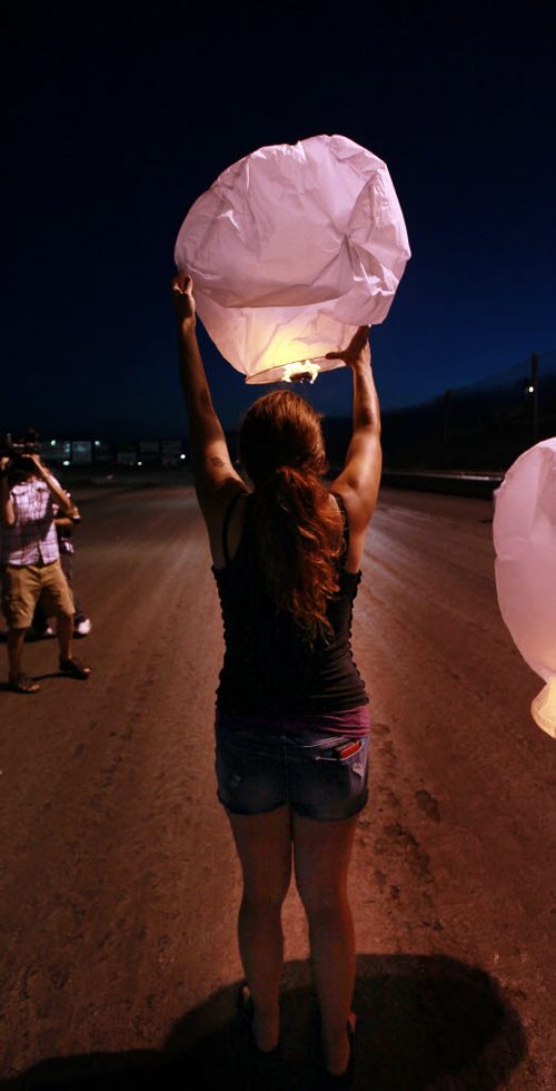 Thelma Krull's daughter Lisa Marquis Besser launches a floating Chinese Lantern at Red River Speedway last night in a vigil to keep search efforts for her missing mom alive. See story. Jauly 27, 2015 - (Phil Hossack / Winnipeg Free Press)   Thelma Krulls family is pressing ahead with efforts to keep the search for the missing 57-year-old grandmother in the news.  "Were reviewing everything at the moment," Krull's daughter Lisa Marquis Besser said Monday.   Thelma Krull CP Thelma Krull Besser said shes meeting with police later today, and at the familys request and weather permitting, there will be an event at the Red River Speedway tonight to publicize the ongoing search.  "I asked for the meeting with police," Besser said, "To touch base, to see what different things (to do) and what we can rule out."  Around 9:30 p.m., following the races are over at the speedway this evening, the family plans to hand out flameless candles in the stands and release Chinese lanterns in an effort to keep attention on Krulls disappearance. That event, which the family is calling Keep the Light On, was originally scheduled for last Thursday but the races were rained out.  As of today, Krull has been missing for 16 straight days.  Despite exhaustive searches, nothing has been reported publicly to advance the case and the family is desperate to find the missing woman.  "Two weeks into it, were not sure what were supposed to be doing," Besser said. Krull was last seen at 7:23 a.m. on July 11, leaving her home in Harbourview South to go for a walk in the Valley Gardens area. She had been taking long walks recently in preparation to go hiking in B.C. later this summer, but she missed her grandson's birthday and her family has said it's extremely out of character for her not to be in contact with them.  Krull's glasses were found in the Valley Gardens area July 15. Police said investigators recovered other items, but wouldn't confirm whether they belonged to Krull.  By