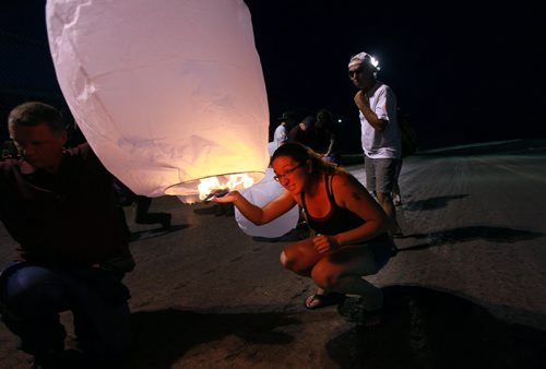 Thelma Krull's daughter Lisa Marquis Besser lights a floating Chinese Lantern at Red River Speedway last night in a vigil to keep search efforts for her missing mom alive. See story. Jauly 27, 2015 - (Phil Hossack / Winnipeg Free Press)   Thelma Krulls family is pressing ahead with efforts to keep the search for the missing 57-year-old grandmother in the news.  "Were reviewing everything at the moment," Krull's daughter Lisa Marquis Besser said Monday.   Thelma Krull CP Thelma Krull Besser said shes meeting with police later today, and at the familys request and weather permitting, there will be an event at the Red River Speedway tonight to publicize the ongoing search.  "I asked for the meeting with police," Besser said, "To touch base, to see what different things (to do) and what we can rule out."  Around 9:30 p.m., following the races are over at the speedway this evening, the family plans to hand out flameless candles in the stands and release Chinese lanterns in an effort to keep attention on Krulls disappearance. That event, which the family is calling Keep the Light On, was originally scheduled for last Thursday but the races were rained out.  As of today, Krull has been missing for 16 straight days.  Despite exhaustive searches, nothing has been reported publicly to advance the case and the family is desperate to find the missing woman.  "Two weeks into it, were not sure what were supposed to be doing," Besser said. Krull was last seen at 7:23 a.m. on July 11, leaving her home in Harbourview South to go for a walk in the Valley Gardens area. She had been taking long walks recently in preparation to go hiking in B.C. later this summer, but she missed her grandson's birthday and her family has said it's extremely out of character for her not to be in contact with them.  Krull's glasses were found in the Valley Gardens area July 15. Police said investigators recovered other items, but wouldn't confirm whether they belonged to Krull.  By th