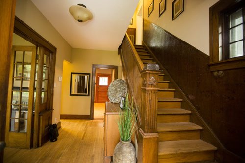 The staircase is a beautiful wooden affair in this Riverview home in Winnipeg on Tuesday, July 28, 2015.  Mikaela MacKenzie / Winnipeg Free Press