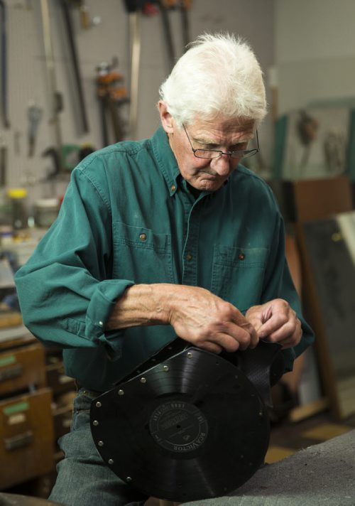 Alf Dick, volunteer at the MCC thrift store, makes purses out of old vinyl records in Winnipeg on Tuesday, July 28, 2015.  Mikaela MacKenzie / Winnipeg Free Press