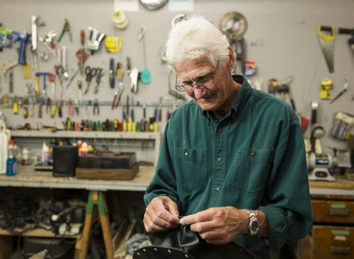 Alf Dick, volunteer at the MCC thrift store, makes purses out of old vinyl records in Winnipeg on Tuesday, July 28, 2015.  Mikaela MacKenzie / Winnipeg Free Press