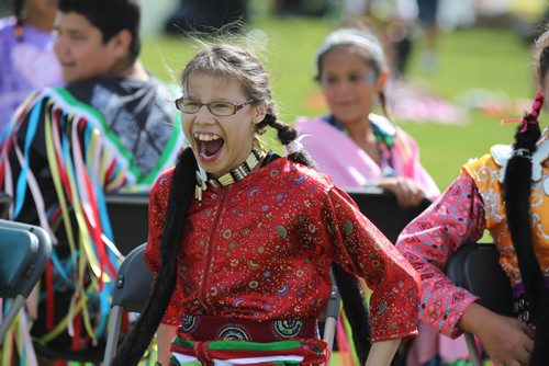 Twelve-year-old Jungle Dancer, Angel Best , shows her excitement as she plays musical chairs with fellow dancers during the Gilbert Park Community Pow Wow Tuesday presented by Gilbert Park Going Places Culture Club.   July 28,, 2015 Ruth Bonneville / Winnipeg Free Press