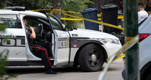 Police Cruisers block off a lane  Taft Cresc behind  743 Nassau south Tuesday afternoon after a shooting sent one man to hospital. See  story. July 28, 2015 - (Phil Hossack / Winnipeg Free Press) **Not sure this is the house involved but most of the tape centred around it.