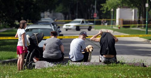 Neighborhood residents peer down Nassau St South towards Taft Cresc Tuesday afternoon after a shooting sent one man to hospital. See  story. July 28, 2015 - (Phil Hossack / Winnipeg Free Press)