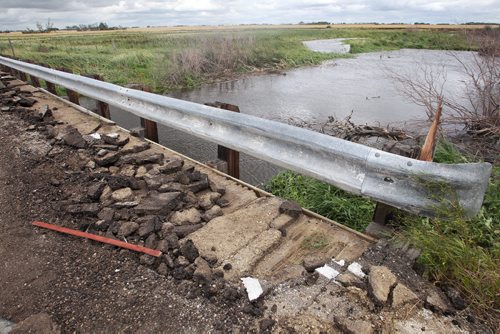 Pavement rubble sits on a small bridge damaged by a tornado Monday night on Hwy 256 close to Tilston, MB.  150728 July 28, 2015 MIKE DEAL / WINNIPEG FREE PRESS