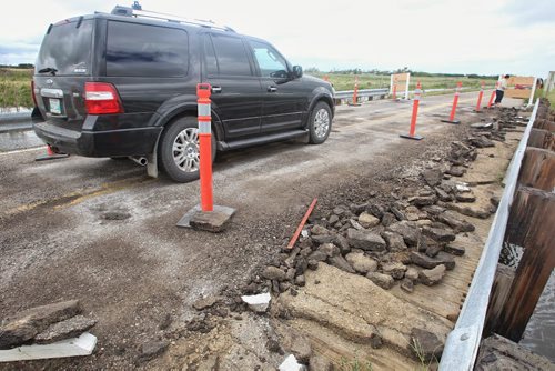 A van carefully drives across a small bridge damaged by a tornado Monday night on Hwy 256 close to Tilston, MB.  150728 July 28, 2015 MIKE DEAL / WINNIPEG FREE PRESS