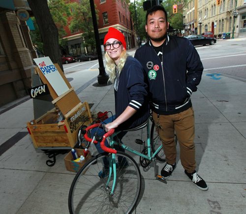 Cycling Sign Painters Bridgette Ellen and Joseph Pilapil pose with their rig, a bike and cart and folding easel. . See  Dave Sanderson story. July 27, 2015 - (Phil Hossack / Winnipeg Free Press)