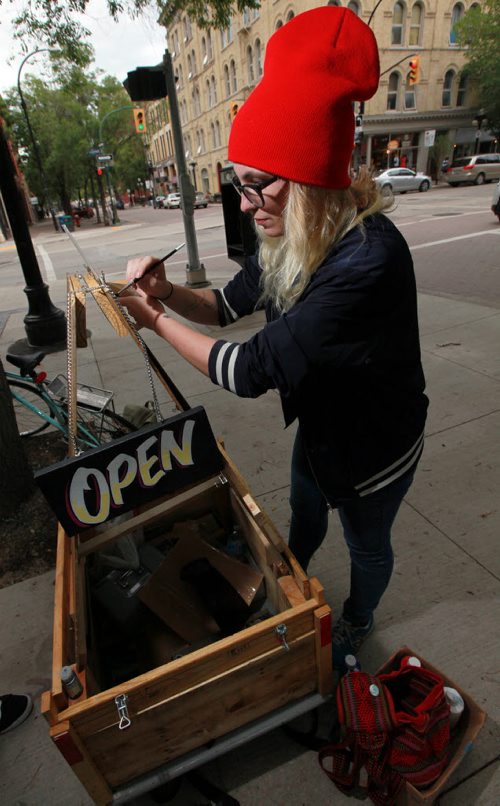 Cycling Sign Painter Bridgette Ellen works out of her rig, a bike and cart and folding easel. . See  Dave Sanderson story. July 27, 2015 - (Phil Hossack / Winnipeg Free Press)