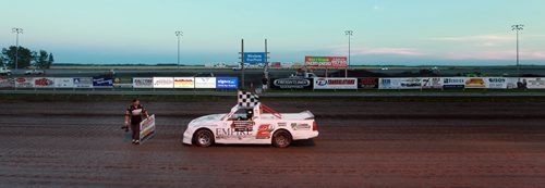 DIRT TRACK RACING - Jamie Vernaus pulls up with the checkered flag in hadn after winning his class Monday night. THe track photographer waits to take the winners photo. See  story. July 27, 2015 - (Phil Hossack / Winnipeg Free Press)